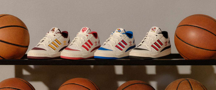 View of adidas basketball sneakers on a ball rack.